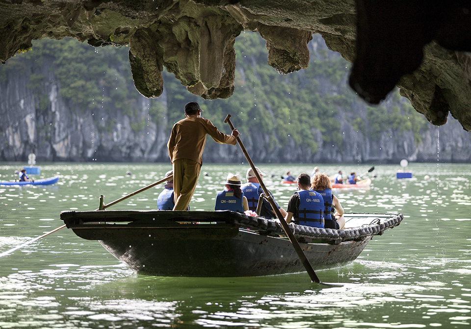 kayaking through cave on halong bay